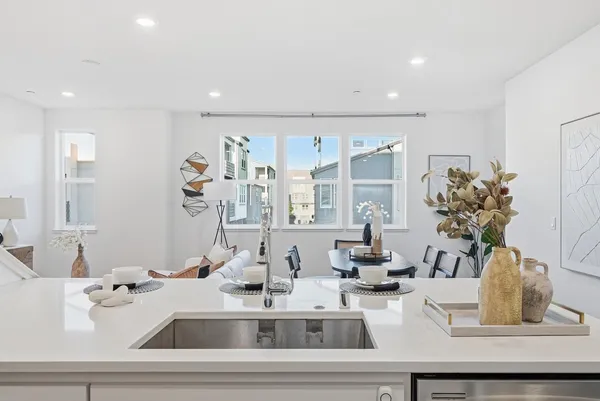 a kitchen with a sink and a mirror