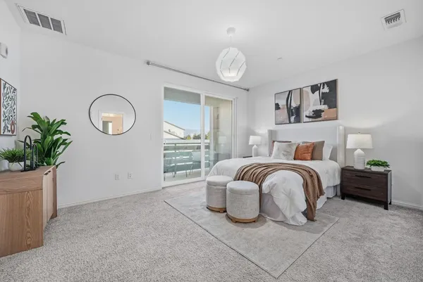 a bedroom with a bed and a potted plant
