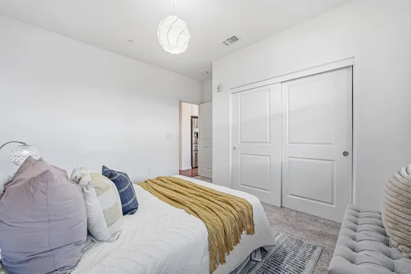 a bedroom with a bed and a window