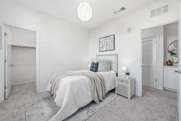 a bedroom with a bed and a window