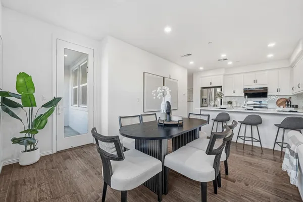 a view of a dining room with furniture and wooden floor