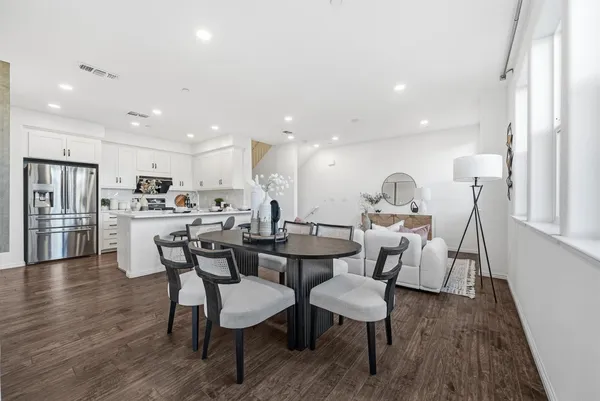 a large kitchen with a table and chairs