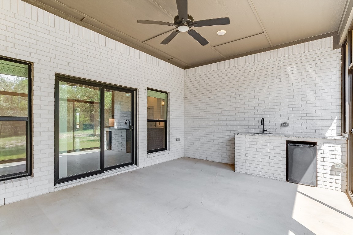 825 County Road 3152 Kempner, TX 76539 - Photo 32 of 34 a view of an empty room with a fireplace and a ceiling fan