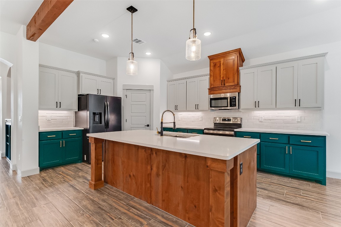 825 County Road 3152 Kempner, TX 76539 - Photo 8 of 34 a kitchen with stainless steel appliances granite countertop a sink a stove a refrigerator and island with wooden floor