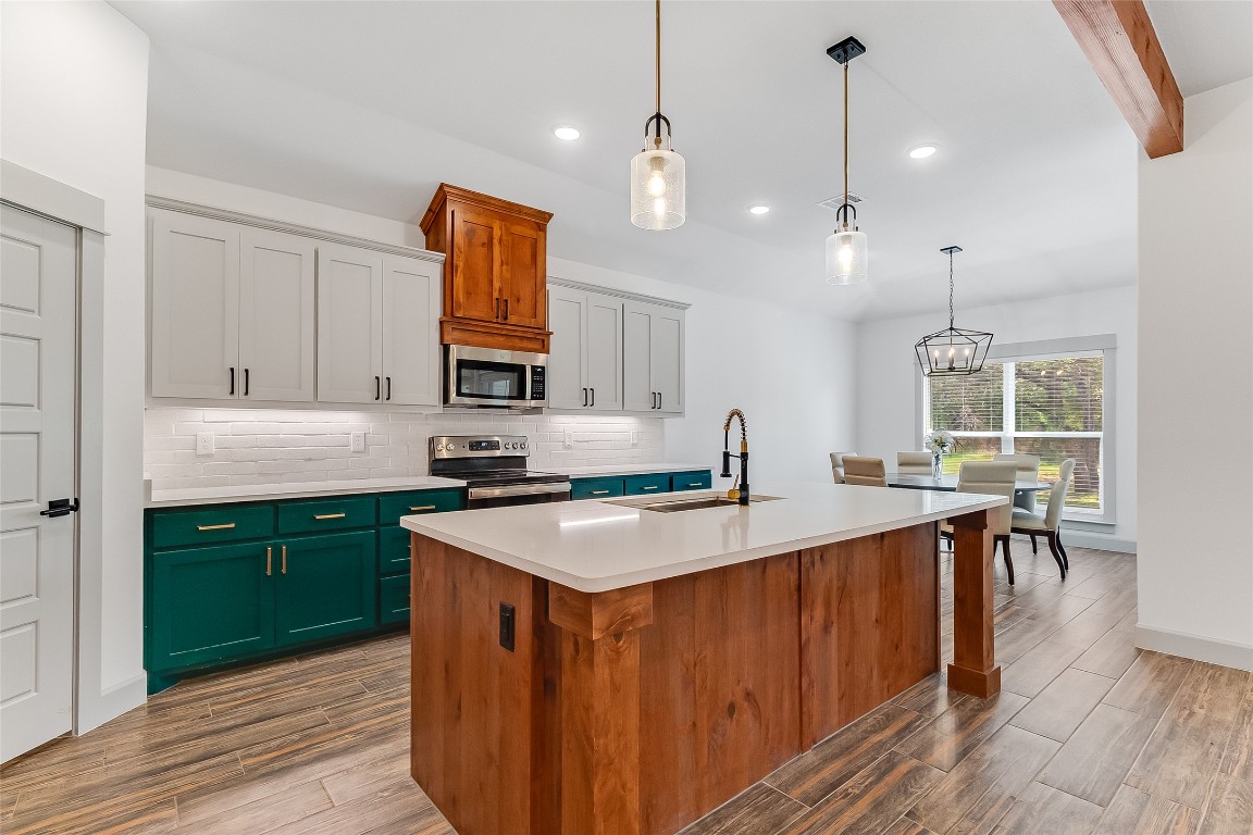 825 County Road 3152 Kempner, TX 76539 - Photo 9 of 34 a kitchen with a sink stove and wooden cabinets
