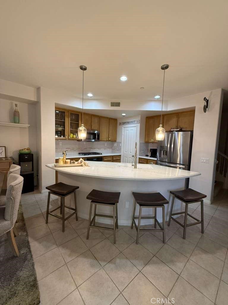 2931 Esperanza Way, Unit B Simi Valley, CA 93063 - Photo 10 of 49 a kitchen with kitchen island granite countertop a table chairs sink and cabinets