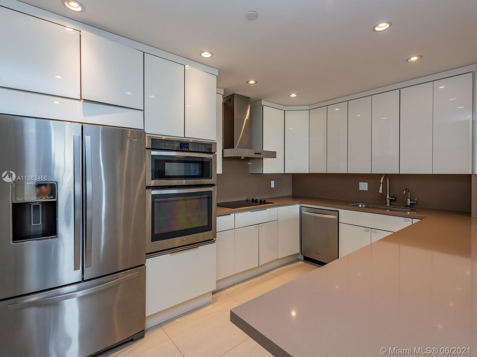 151 Crandon Boulevard, Unit 736 Key Biscayne, FL 33149 - Photo 11 of 38 a kitchen with stainless steel appliances granite countertop a refrigerator sink and stove