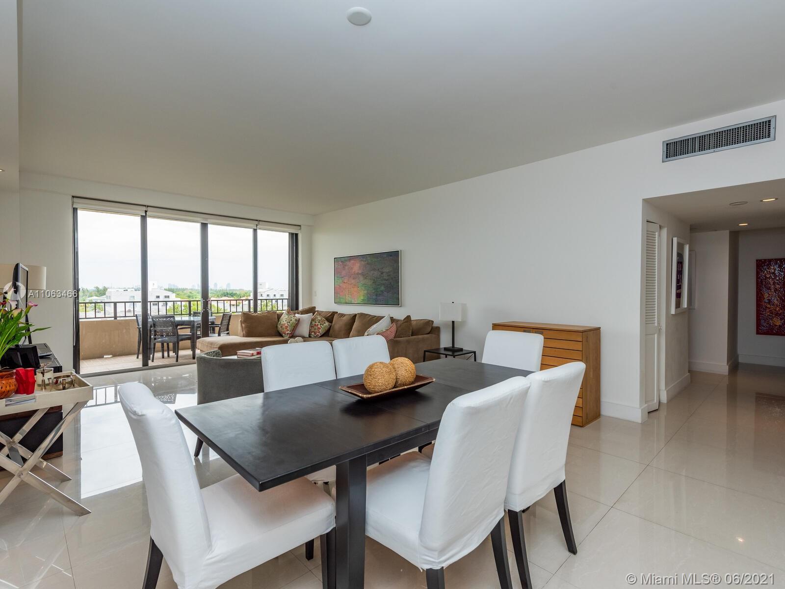 151 Crandon Boulevard, Unit 736 Key Biscayne, FL 33149 - Photo 14 of 38 a view of a dining room with furniture and a floor to ceiling window