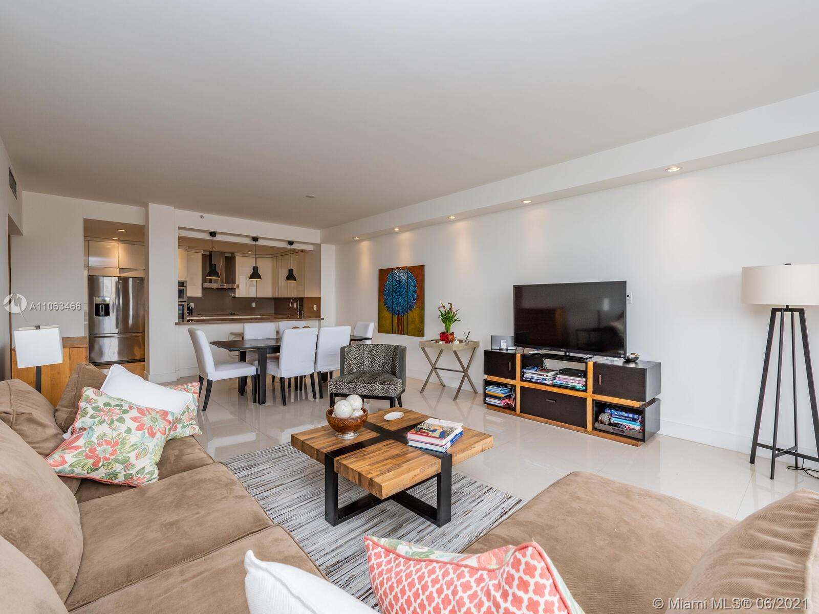 151 Crandon Boulevard, Unit 736 Key Biscayne, FL 33149 - Photo 18 of 38 a living room with furniture and a flat screen tv