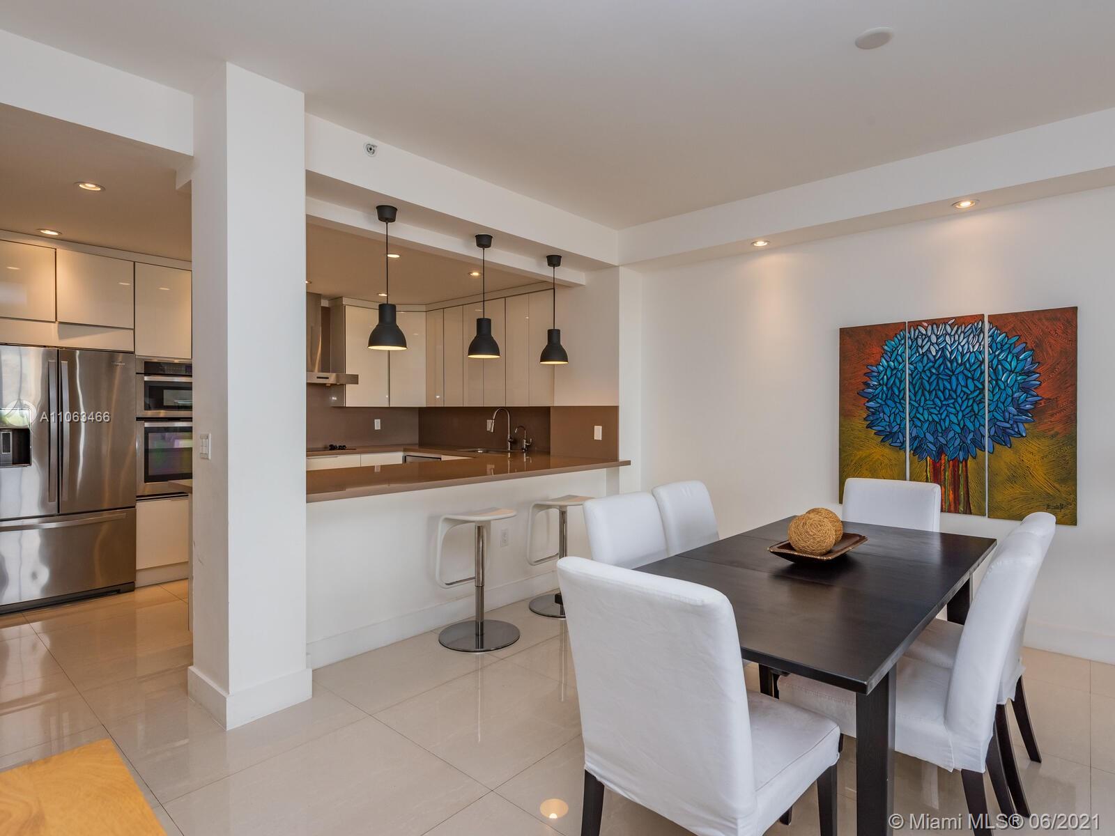 151 Crandon Boulevard, Unit 736 Key Biscayne, FL 33149 - Photo 20 of 38 a living room with stainless steel appliances kitchen island granite countertop furniture and a view of kitchen