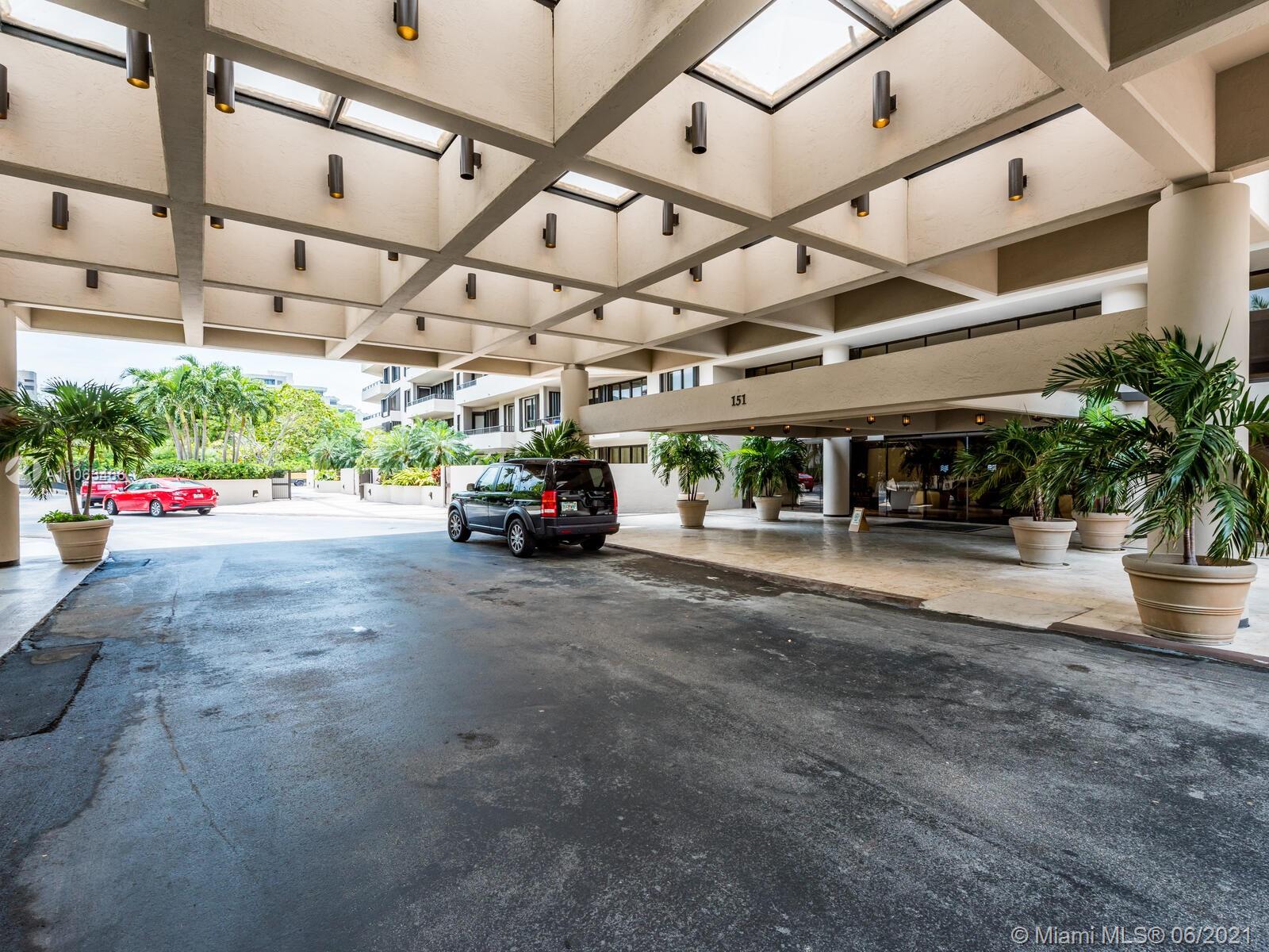 151 Crandon Boulevard, Unit 736 Key Biscayne, FL 33149 - Photo 3 of 38 a view of garage with a car parked under an umbrella