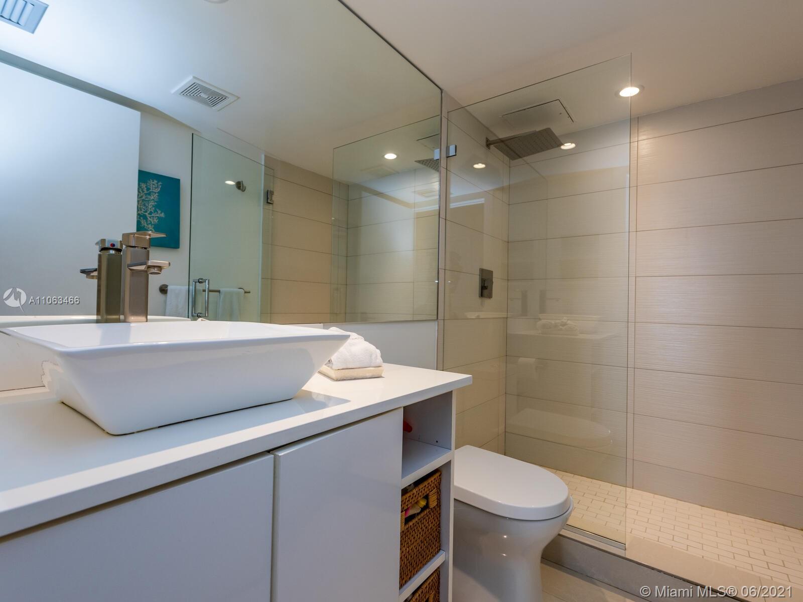 151 Crandon Boulevard, Unit 736 Key Biscayne, FL 33149 - Photo 26 of 38 a bathroom with a sink a toilet and shower