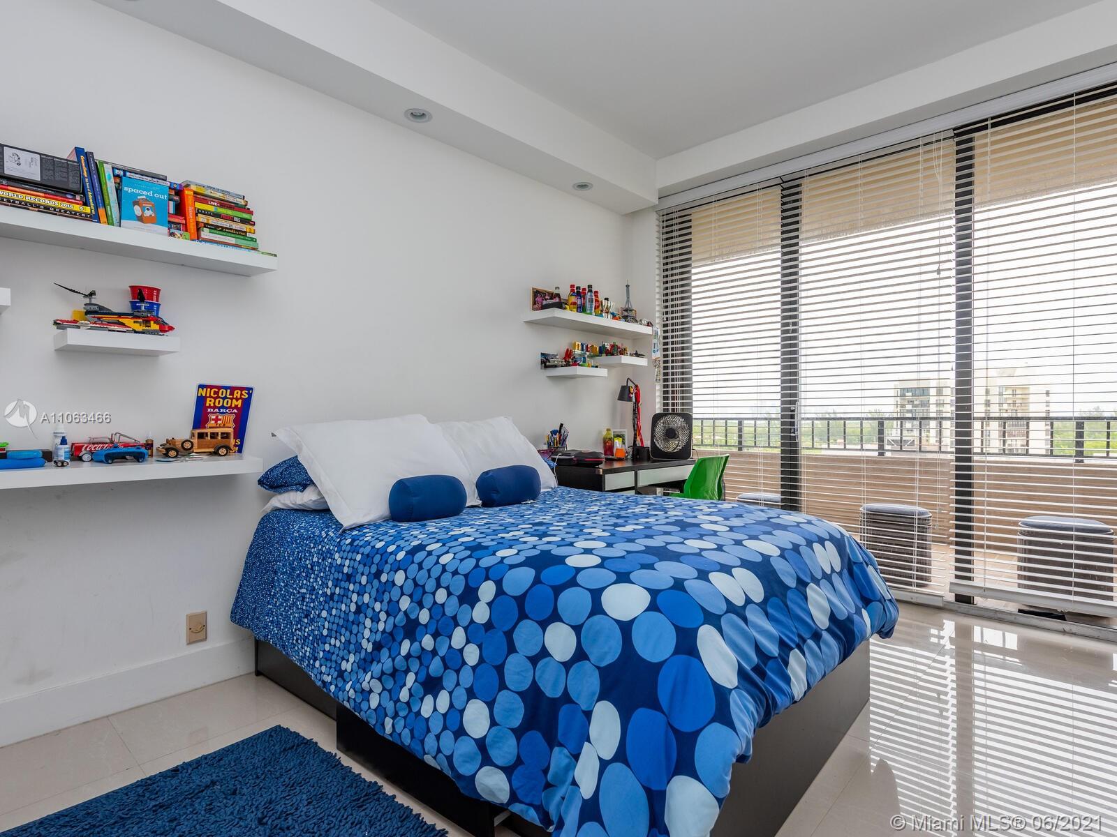 151 Crandon Boulevard, Unit 736 Key Biscayne, FL 33149 - Photo 31 of 38 a bedroom with a bed and a window