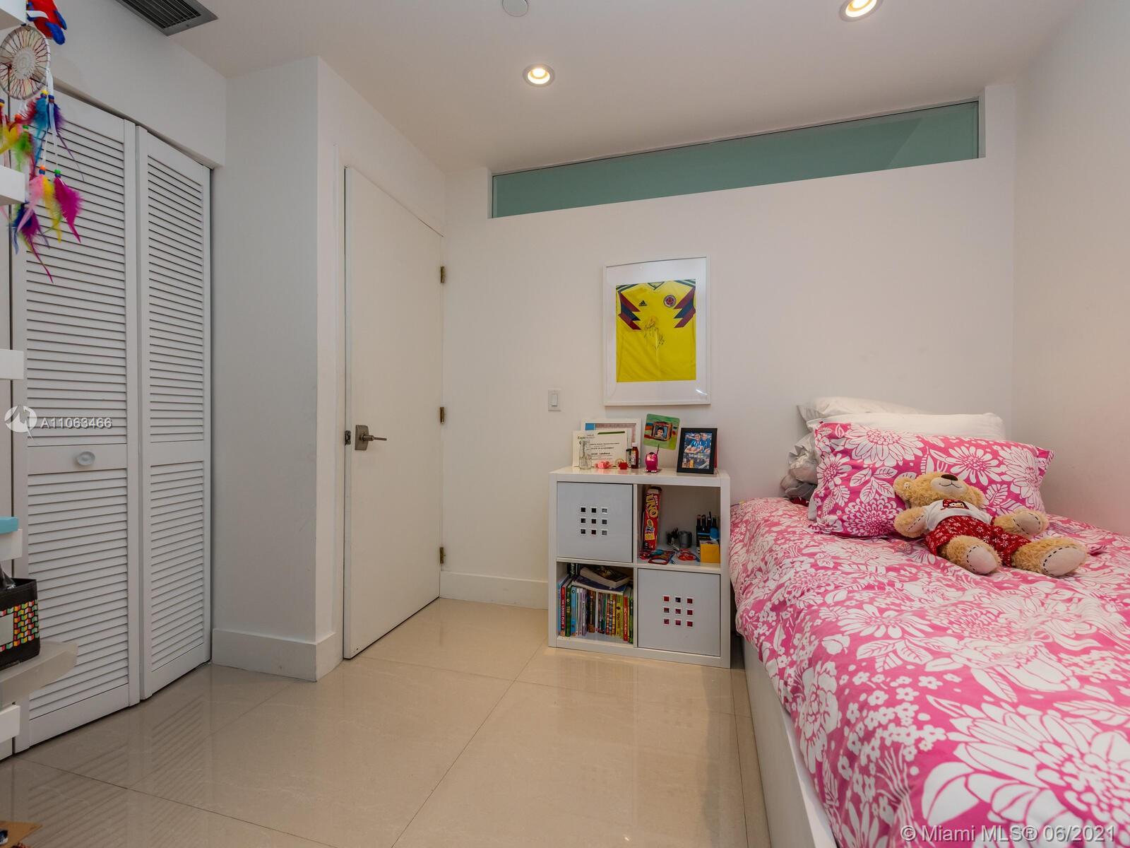 151 Crandon Boulevard, Unit 736 Key Biscayne, FL 33149 - Photo 34 of 38 a bedroom with a bed and painting on the wall