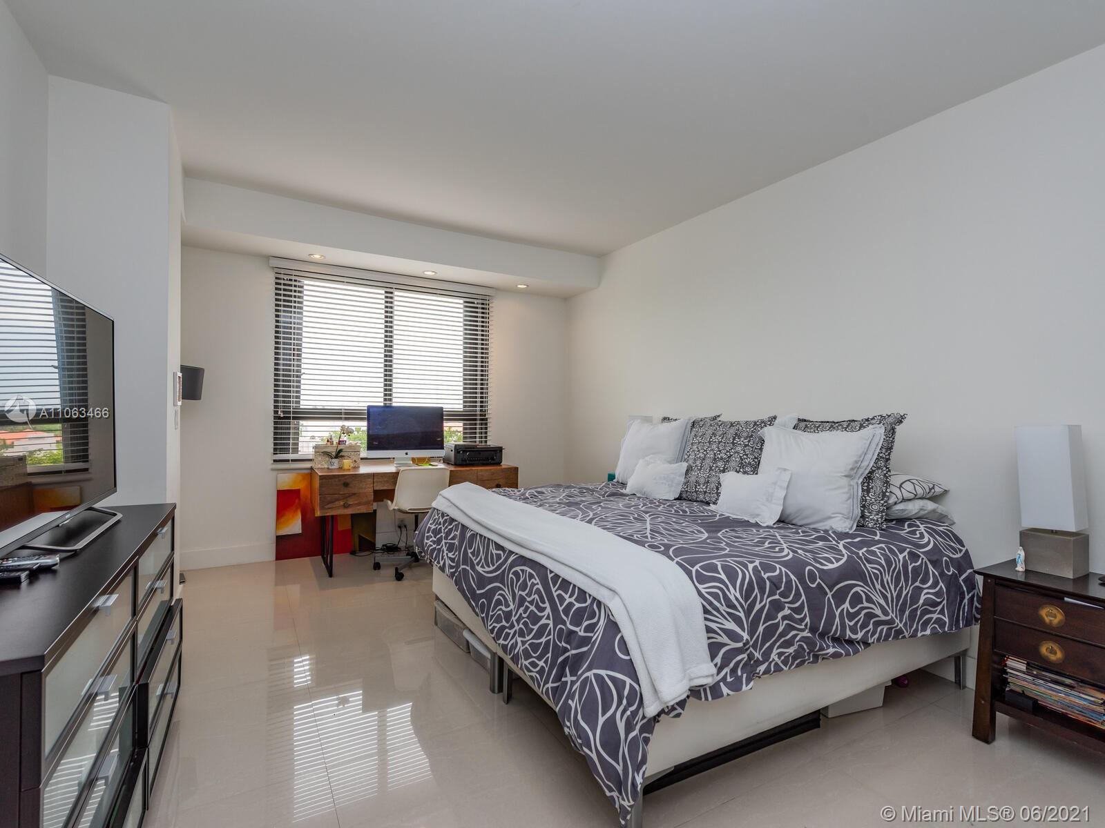 151 Crandon Boulevard, Unit 736 Key Biscayne, FL 33149 - Photo 35 of 38 a bedroom with a bed and a flat screen tv