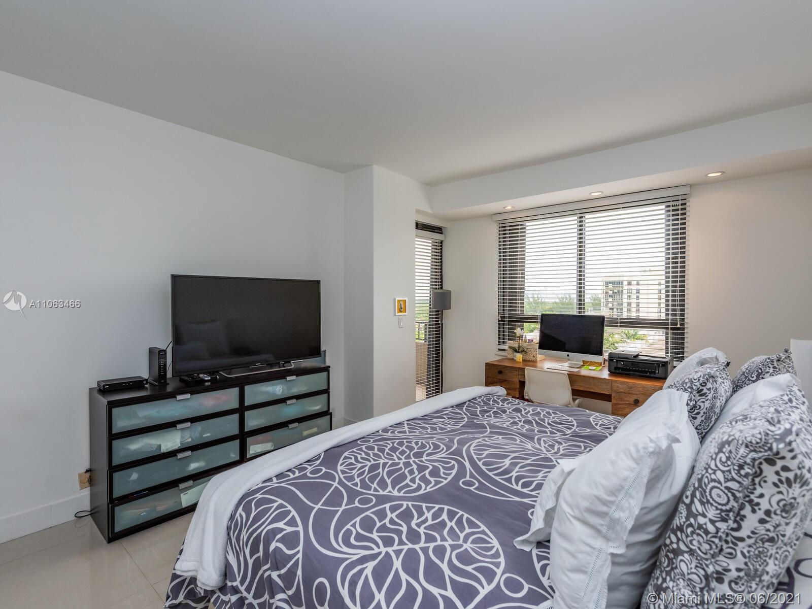 151 Crandon Boulevard, Unit 736 Key Biscayne, FL 33149 - Photo 36 of 38 a bedroom with a bed and a flat screen television