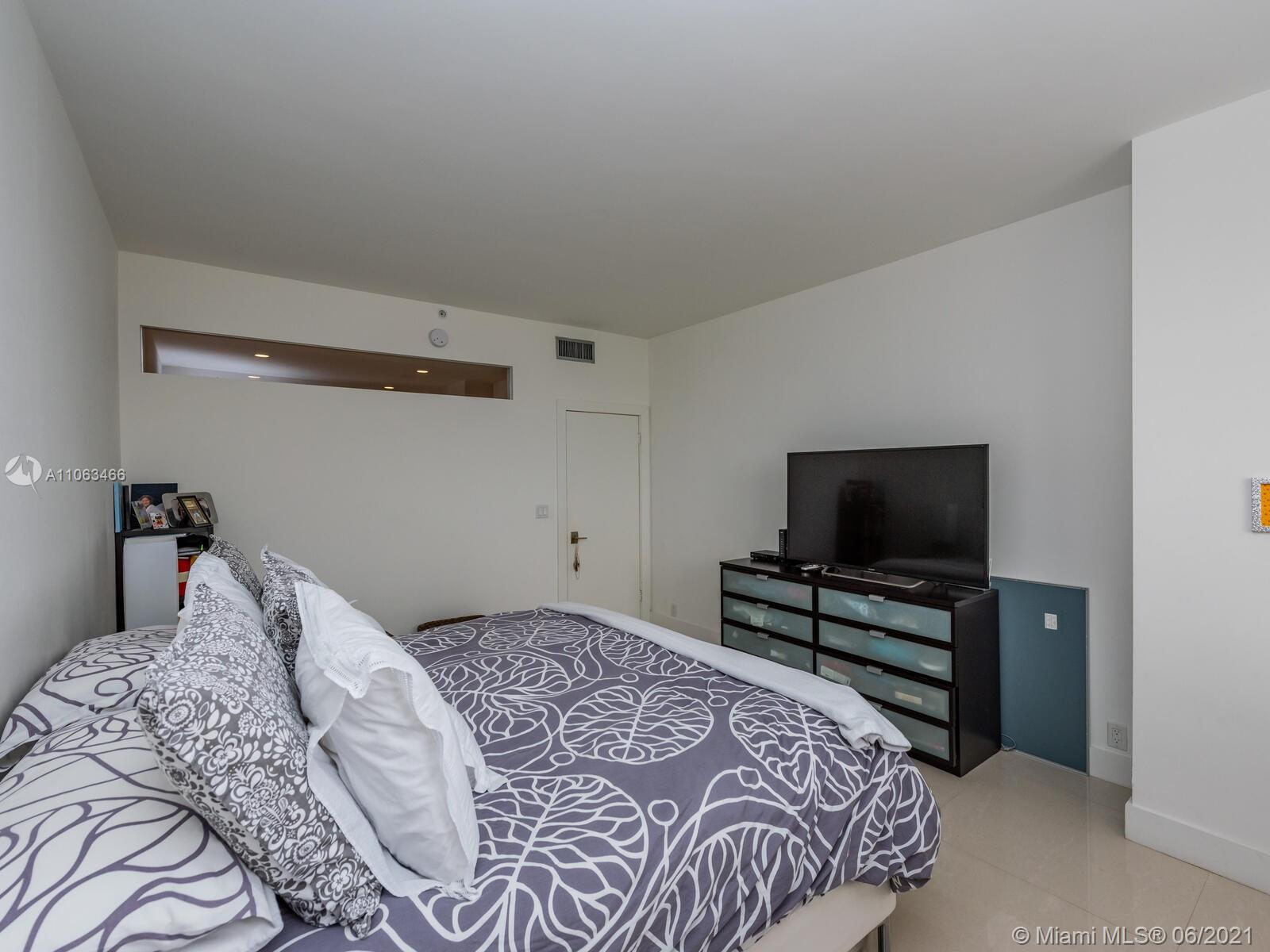 151 Crandon Boulevard, Unit 736 Key Biscayne, FL 33149 - Photo 38 of 38 a bedroom with a bed and a flat screen tv