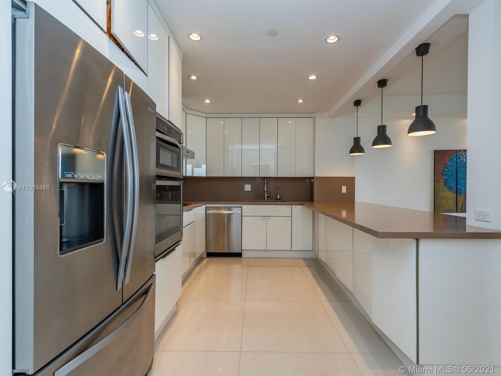 151 Crandon Boulevard, Unit 736 Key Biscayne, FL 33149 - Photo 10 of 38 a large kitchen with stainless steel appliances lots of counter top space