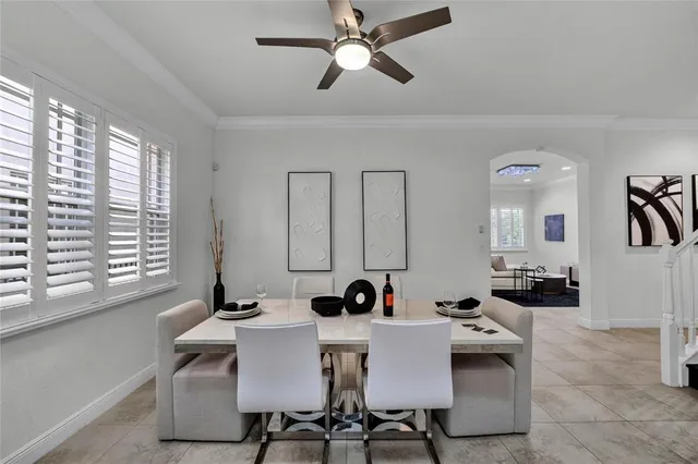 a view of a dining room with furniture and chandelier
