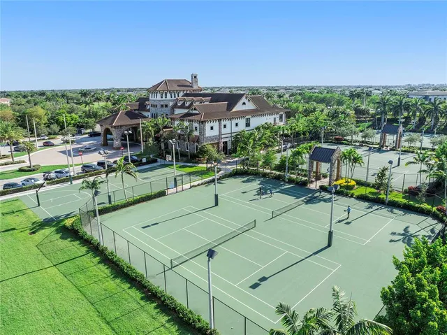 an aerial view of residential houses with outdoor space and swimming pool