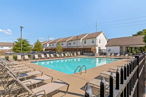 a view of a house with pool and chairs