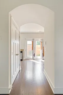 a view of a big room with wooden floor and windows