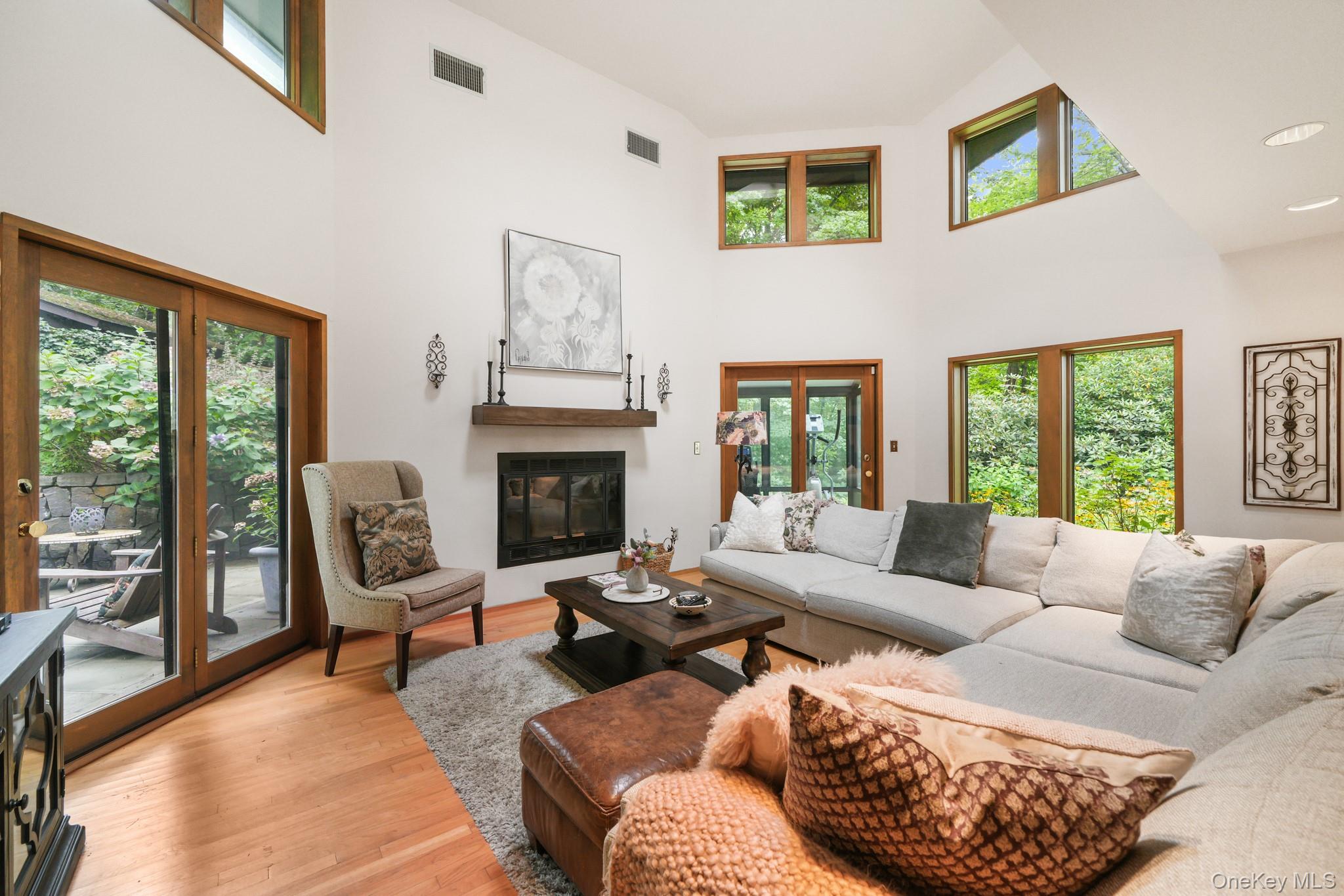155 Revolutionary Road Briarcliff Manor, NY 10510 - Photo 11 of 30 a living room with furniture a large window and a fireplace