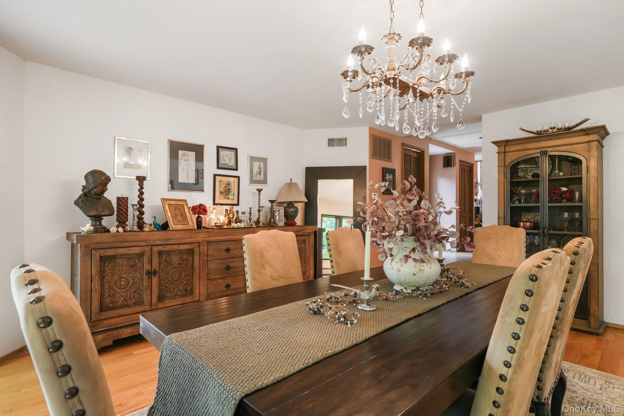 155 Revolutionary Road Briarcliff Manor, NY 10510 - Photo 13 of 30 a view of a dining room with furniture a chandelier and wooden floor