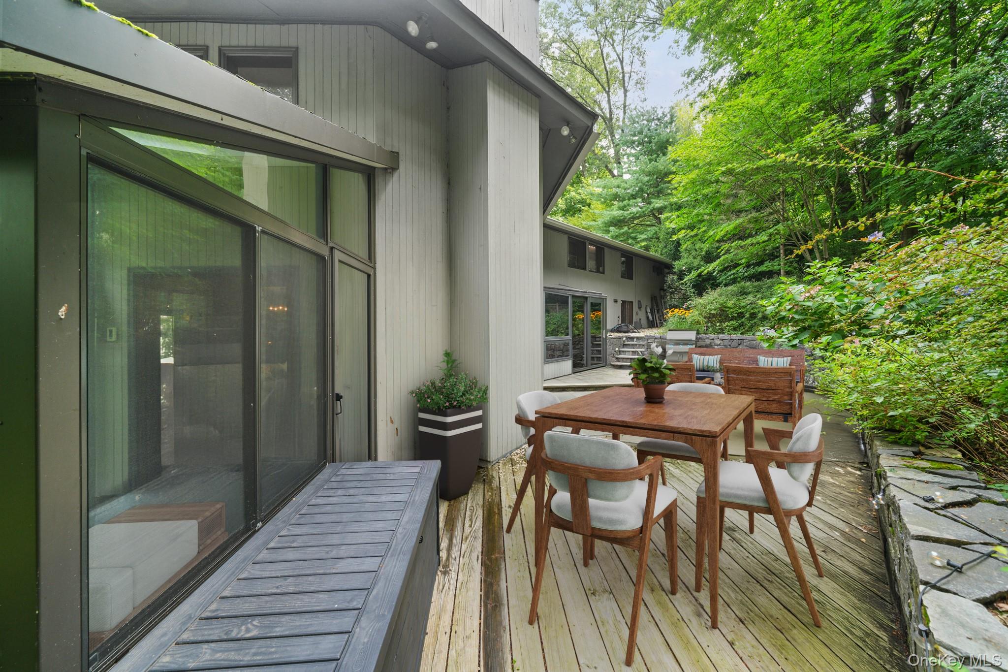 155 Revolutionary Road Briarcliff Manor, NY 10510 - Photo 24 of 30 a view of a patio with table and chairs with wooden floor and fence