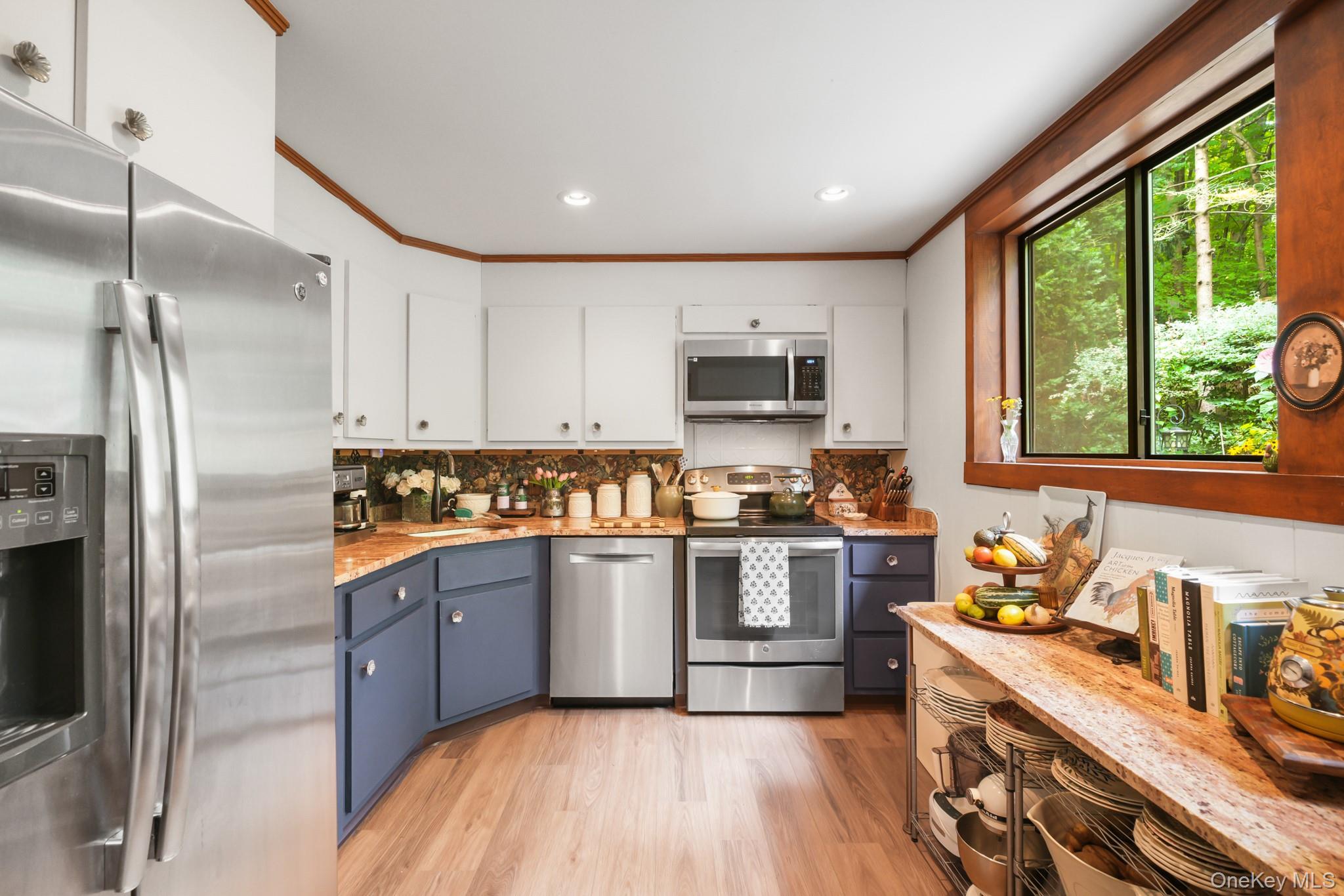 155 Revolutionary Road Briarcliff Manor, NY 10510 - Photo 8 of 30 a kitchen with stainless steel appliances granite countertop a refrigerator a sink dishwasher a stove top oven a refrigerator with the cabinets and wooden floor