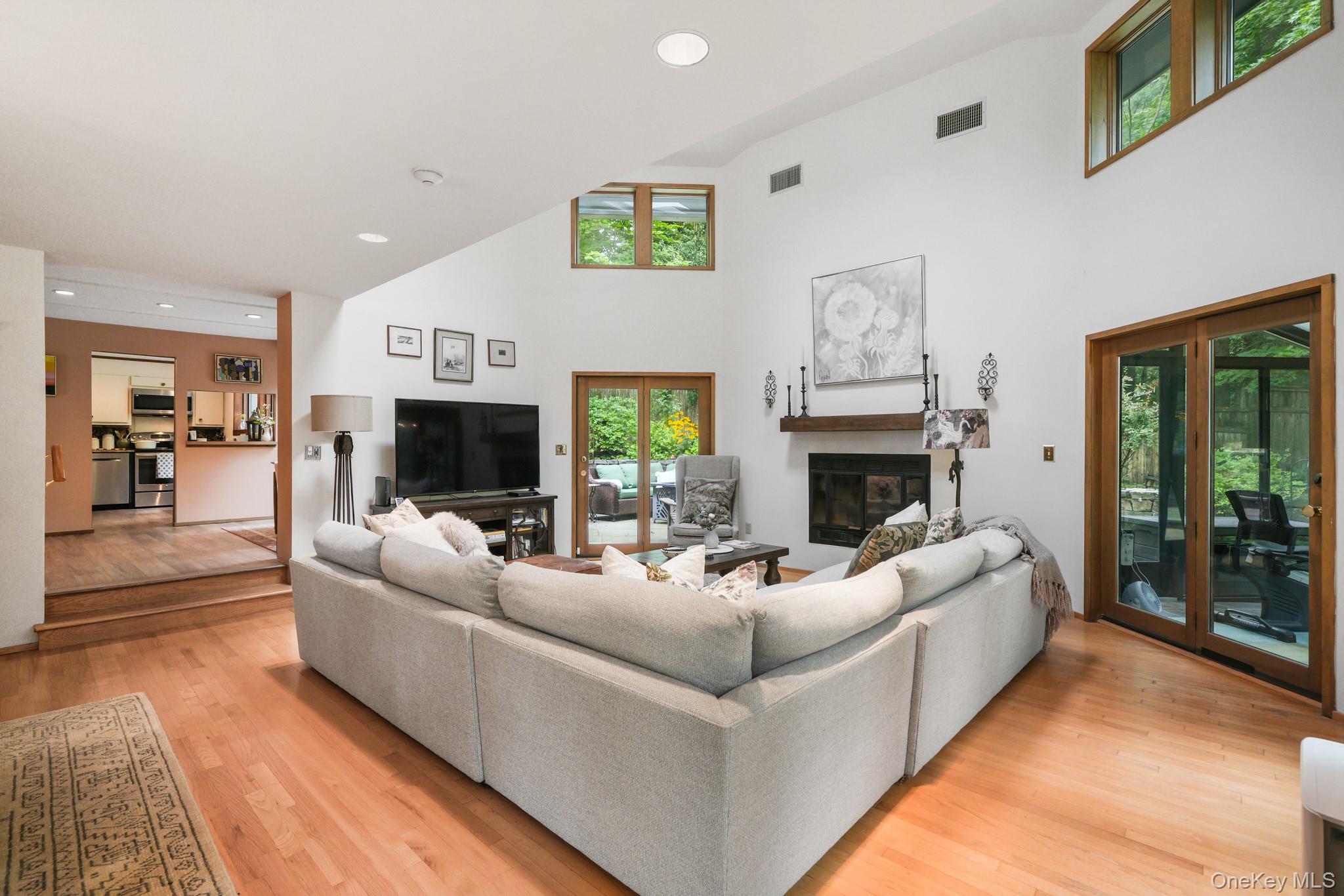 155 Revolutionary Road Briarcliff Manor, NY 10510 - Photo 10 of 30 a living room with furniture a flat screen tv and a fireplace