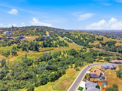 an aerial view of residential house with outdoor space and trees
