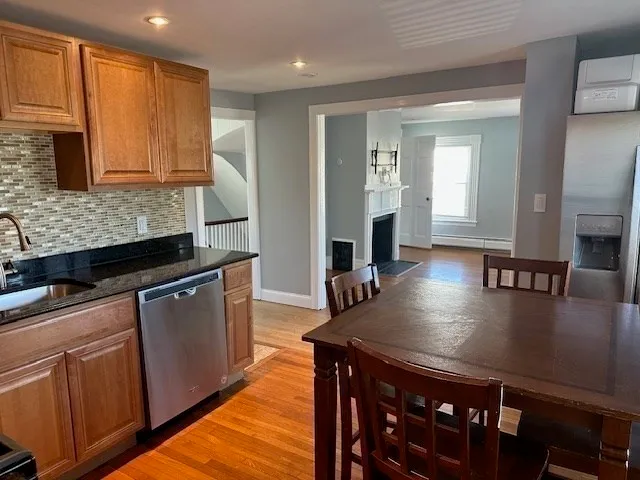 a kitchen with stainless steel appliances granite countertop a sink a stove counter space and cabinets