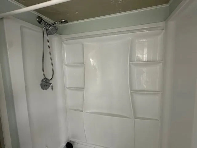 a bathroom with a glass shower door