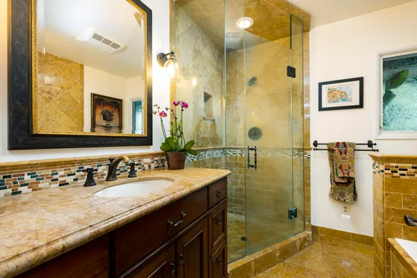 a bathroom with a granite countertop sink mirror and double