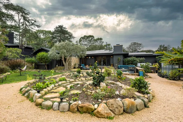 a view of a house with swimming pool and sitting area