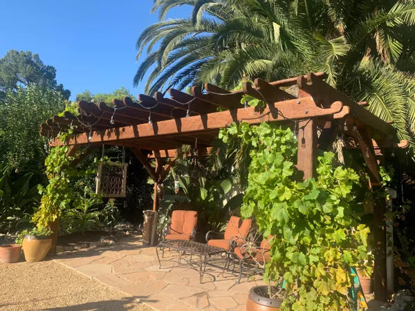 a backyard of a house with table and chairs