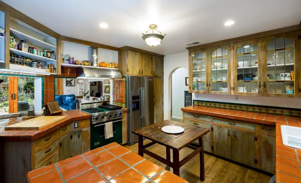a kitchen with stainless steel appliances granite countertop a stove a refrigerator and a dining table