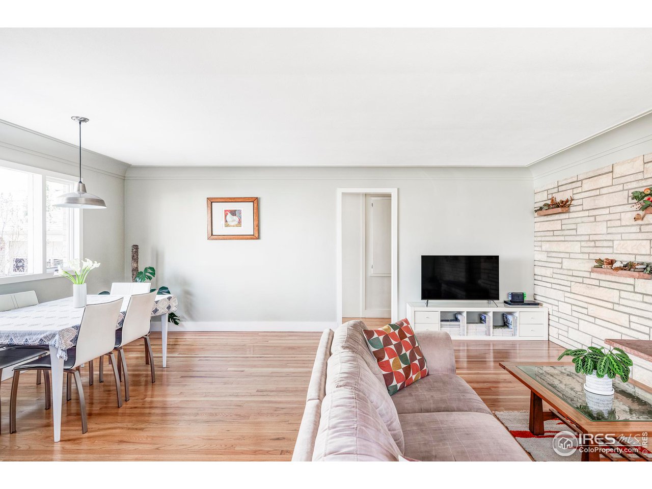 2870 15th Street Boulder, CO 80304 - Photo 3 of 21 The main level welcomes you with gleaming oak floors and a family room with large windows anchored by a distinctive stone fireplace, creating a warm and inviting atmosphere for gatherings or quiet evenings.