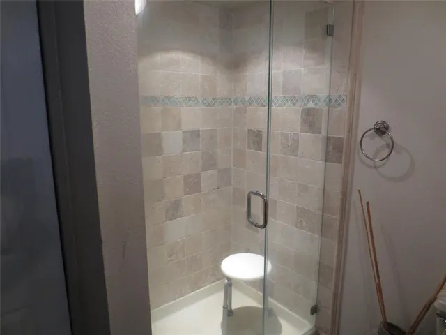 a bathroom with a shower a toilet and a sink