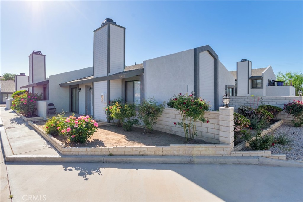 19087 Allegheny Road Apple Valley, CA 92307 - Photo 21 of 47 a front view of a house with a garden