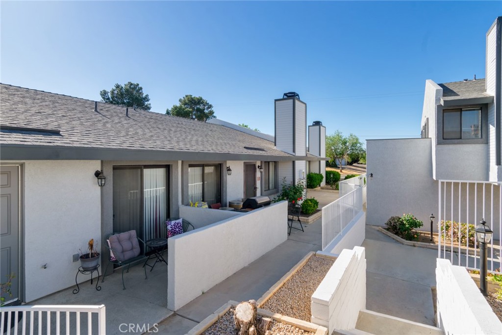 19087 Allegheny Road Apple Valley, CA 92307 - Photo 25 of 47 a view of a patio with couches table and chairs and potted plants