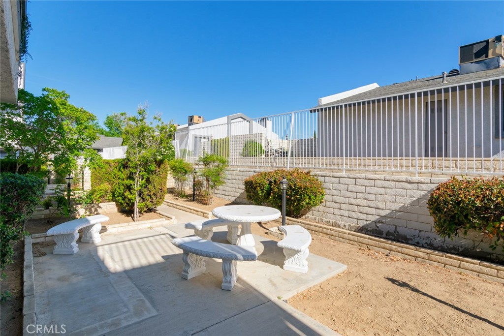 19087 Allegheny Road Apple Valley, CA 92307 - Photo 28 of 47 a view of a patio with couches table and chairs and potted plants
