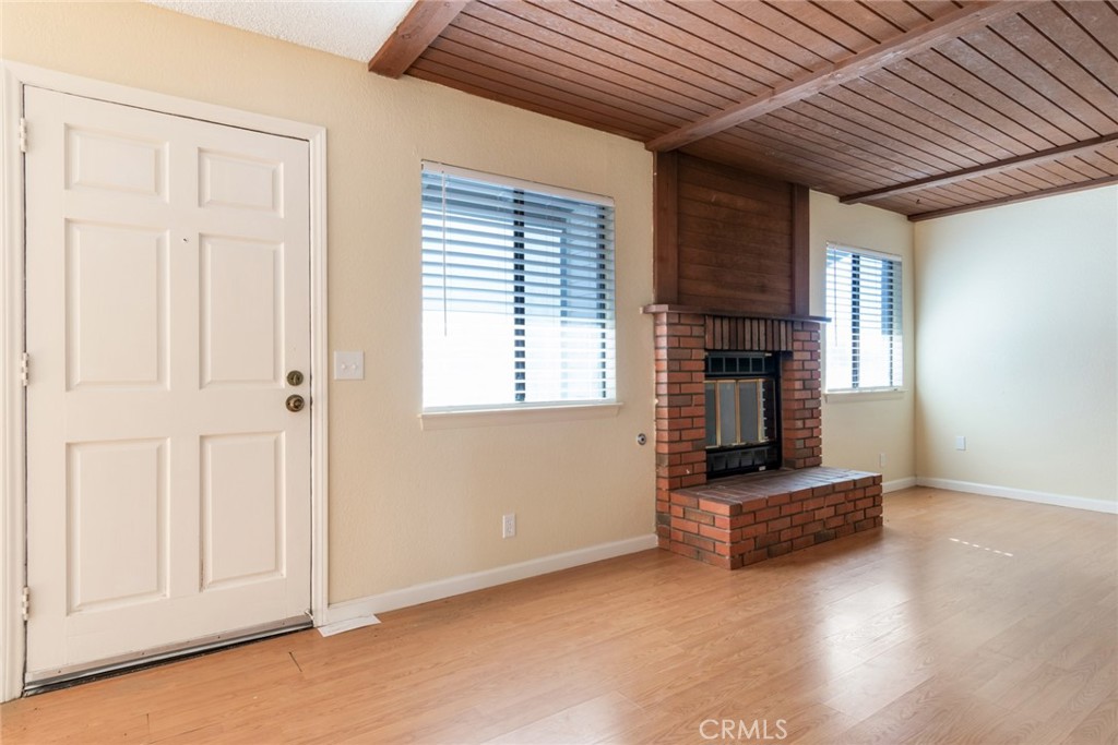 19087 Allegheny Road Apple Valley, CA 92307 - Photo 35 of 47 a living room with furniture a fireplace and a window