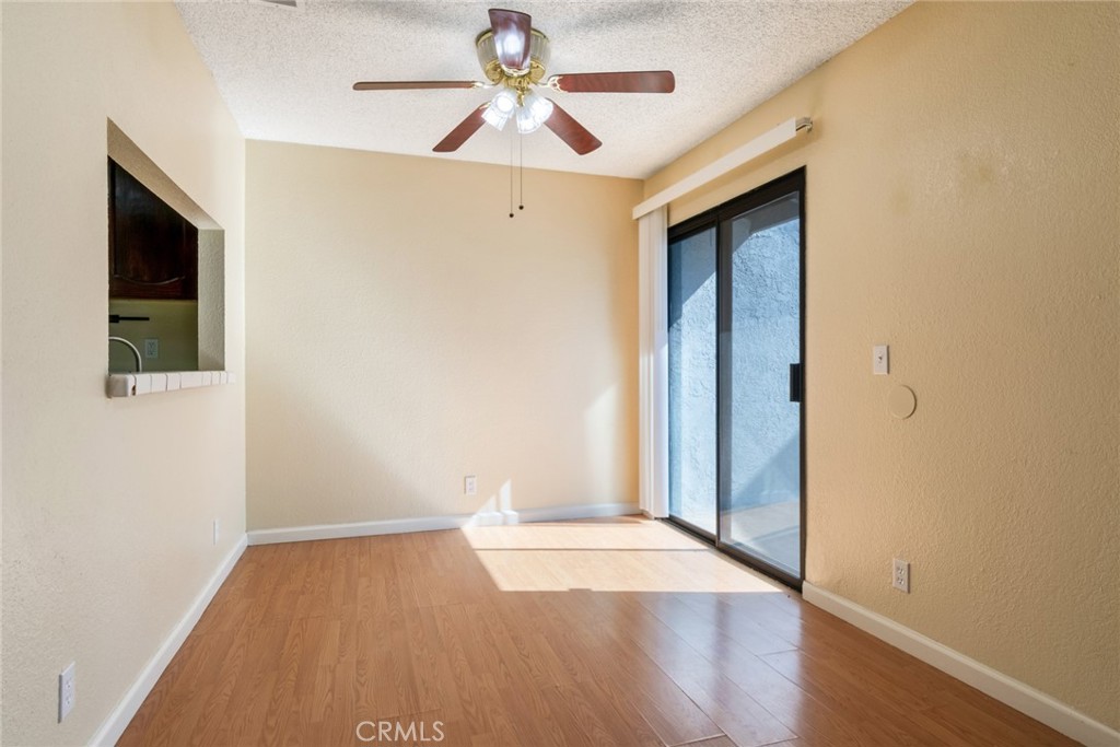 19087 Allegheny Road Apple Valley, CA 92307 - Photo 37 of 47 an empty room with wooden floor and fan
