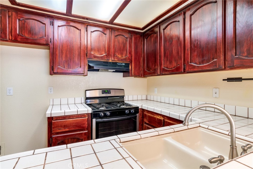 19087 Allegheny Road Apple Valley, CA 92307 - Photo 39 of 47 a kitchen with stainless steel appliances a stove a sink and a microwave