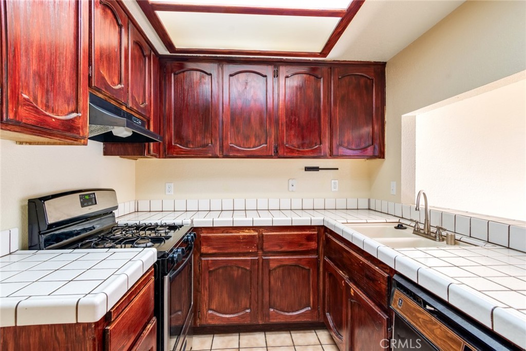 19087 Allegheny Road Apple Valley, CA 92307 - Photo 40 of 47 a kitchen with a sink and a stove top oven