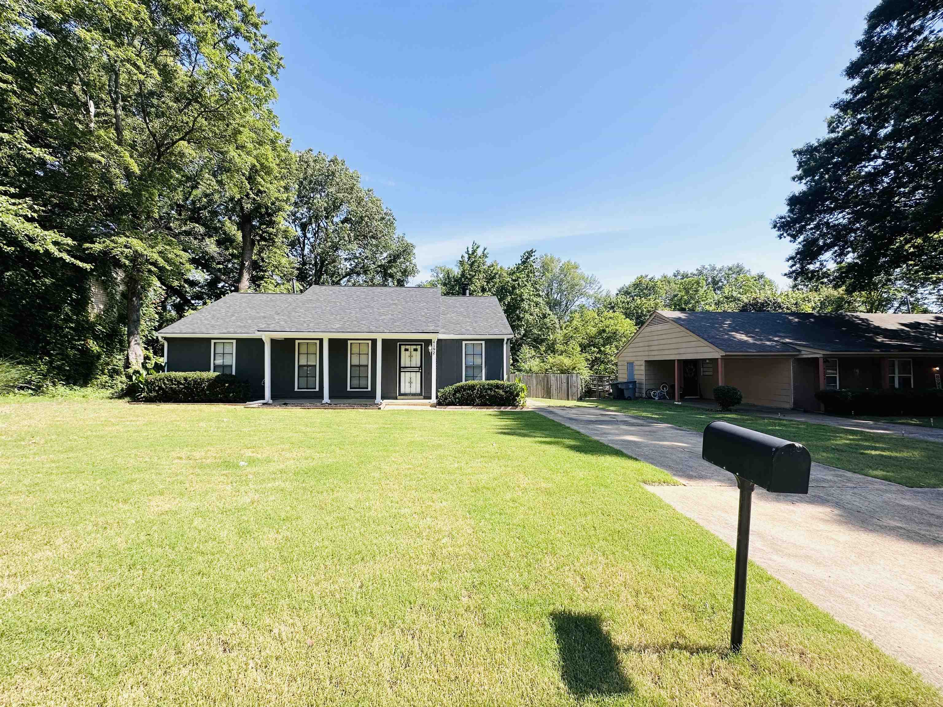 a front view of house with yard and swimming pool