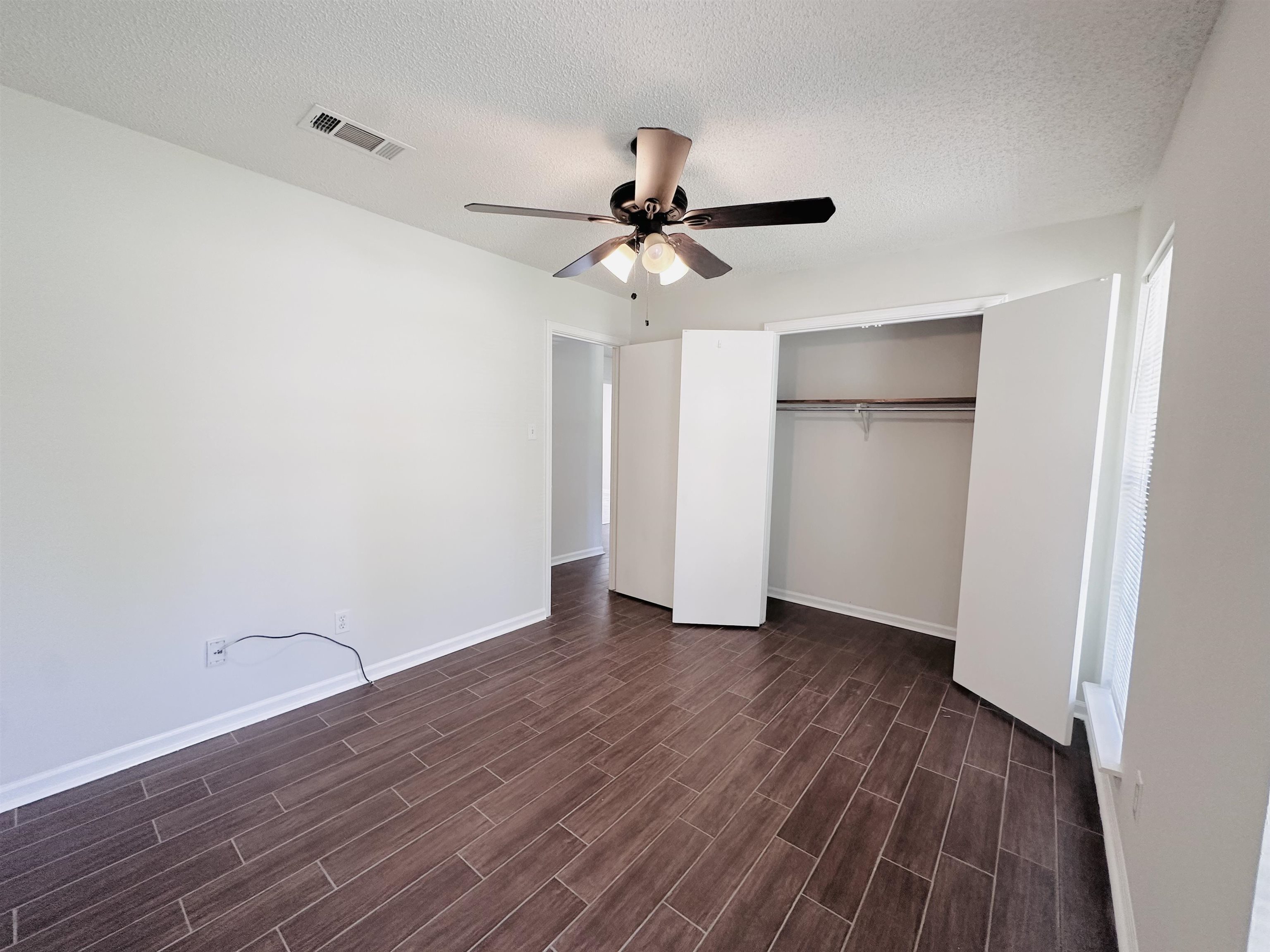 4192 Riche Road Memphis, TN 38128 - Photo 24 of 32 an empty room with a hardwood and ceiling fan