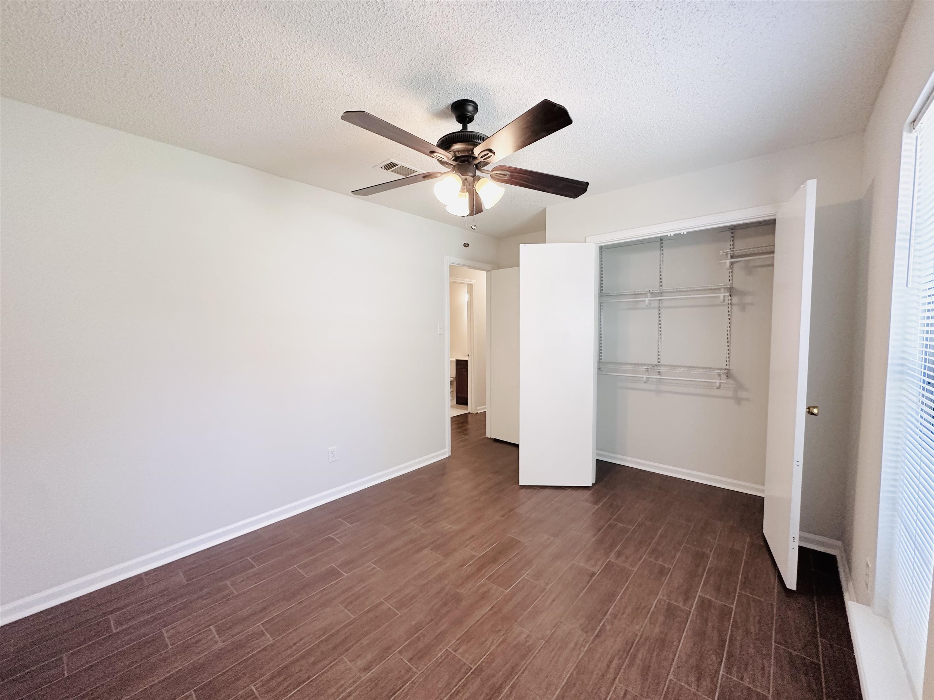 4192 Riche Road Memphis, TN 38128 - Photo 28 of 32 a view of an empty room with a window and wooden floor